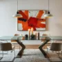 A modern dining room showcasing a bold abstract painting on the wall