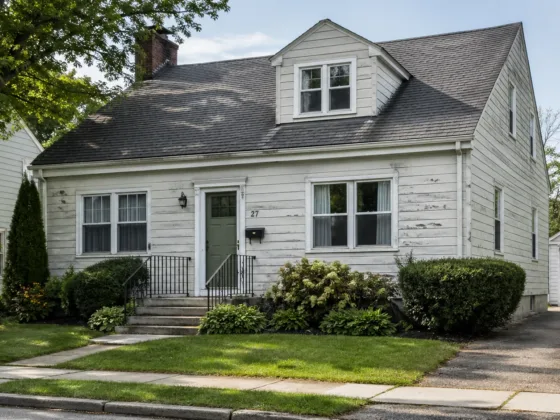 white house exterior with fading paint and visible wear on siding